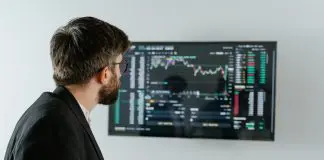 man in office looking at HR statistics on computer