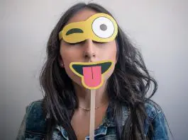 woman wearing happy face disguise