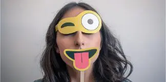woman wearing happy face disguise