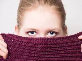 Woman hiding identity behind scarf
