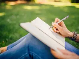 woman sittting in garden writing notes