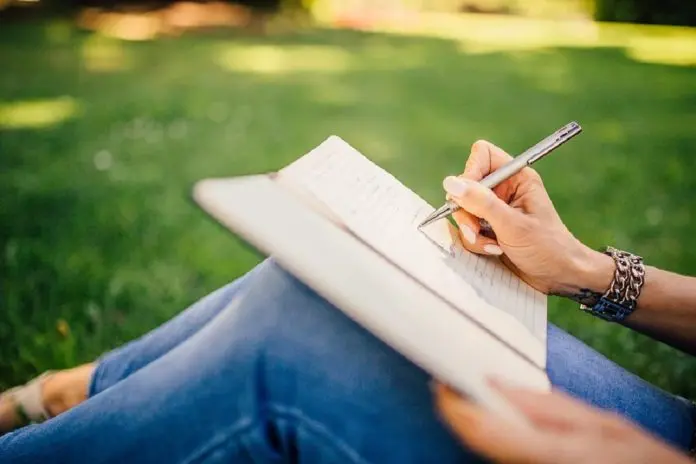 HRHQ writing-interests woman sittting in garden writing notes