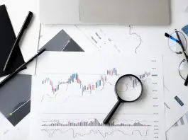 magnifying glass on top of graphs