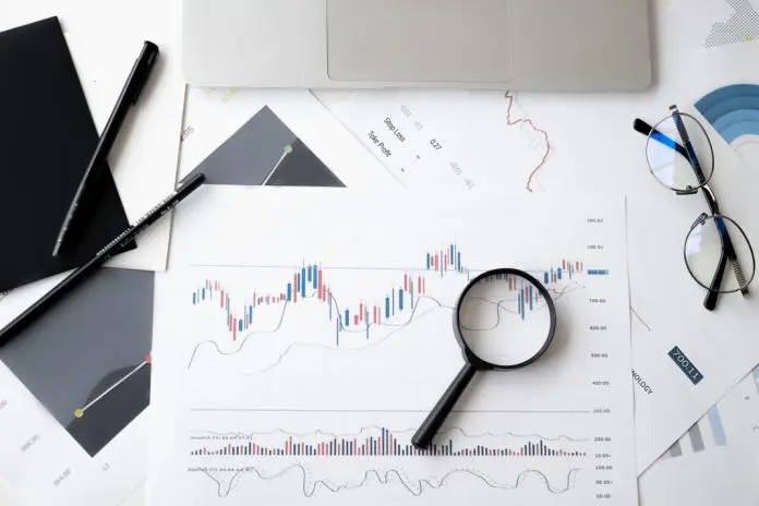 magnifying glass on top of graphs