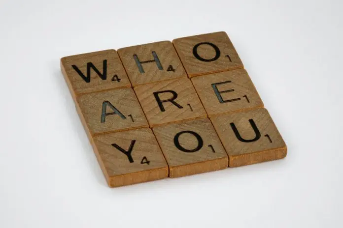 pexels-brett-jordan-7416851 wooden scrabble tiles spelling out "who are you" in a square 3x3