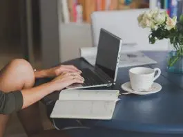 woman working from home at laptop on kitchen