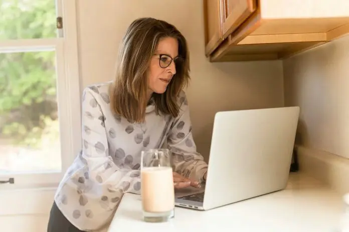 HRHQ Work from home with high energy costs Woman remote working in kitchen