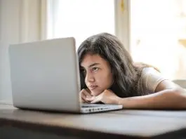 lady bored looking at laptop