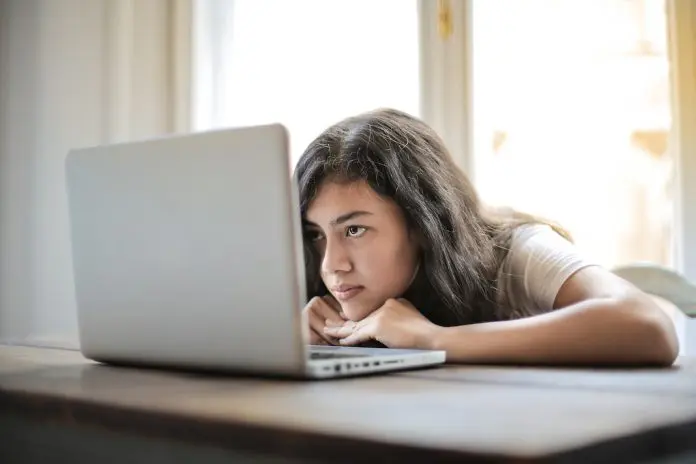pexels-andrea-piacquadio-3807747 lady bored looking at laptop