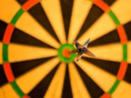 picture of dart in bullseye against blurred out dartboard
