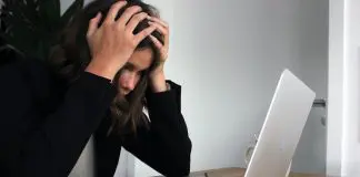 distressed woman sitting at laptop