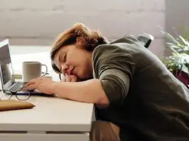 female employee asleep at her desk