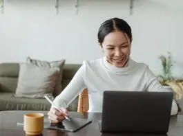 lady on laptop taking notes on conference call