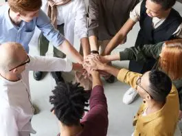 diverse team huddling together
