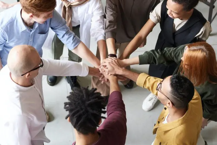 diverse team huddling together