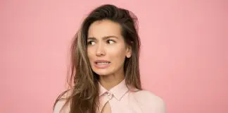 woman in office attire looking concerned