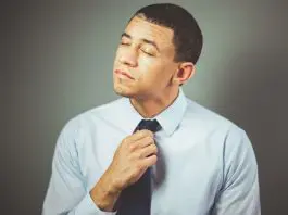 frustrated man tugging at tie