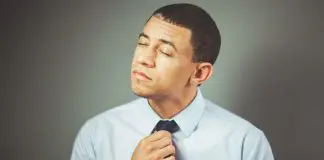 frustrated man tugging at tie