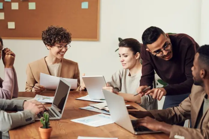 group of highly engaged employees around table