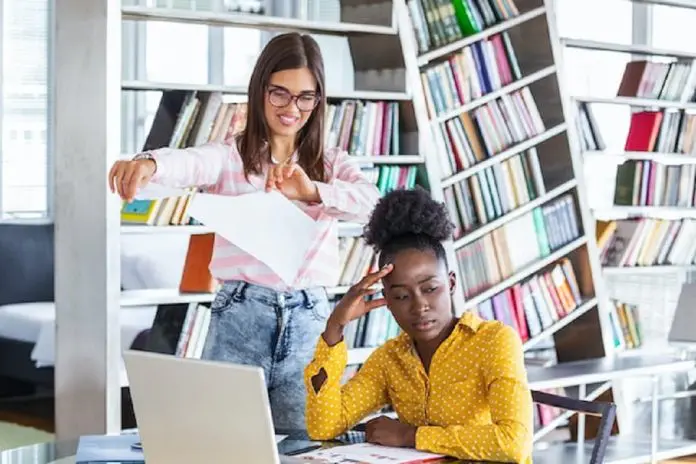 2 women in a n office looking concerned