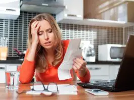 Stressed,Young,Woman,Is,Doing,Banking,And,Administrative,Work,Holding
