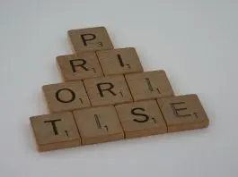 "prioritise" written iin scrabble tiles