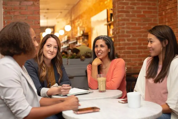 linkedin-sales-solutions-IjkIOe-2fF4-unsplash group of woment sitting around a table chatting
