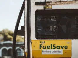 old battered whie and yellow fuel pump gauge
