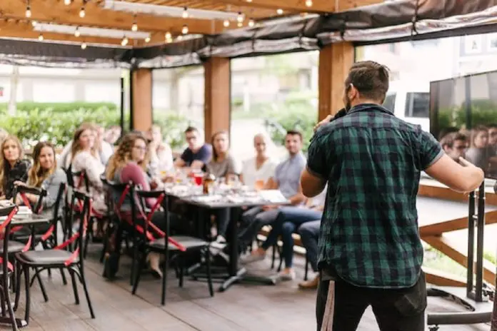 man speaking to a group of people