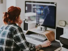 person looking at large font monitor