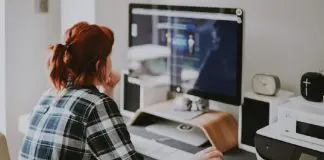 person looking at large font monitor