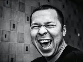black and white photo of man smiling broadly