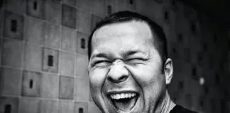 black and white photo of man smiling broadly