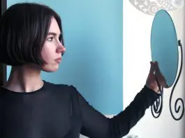 woman looking into mirrorr