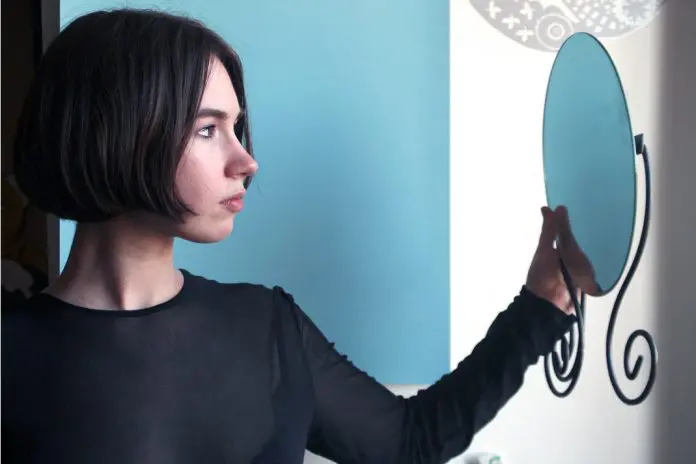 HRHQ Imposter syndrome woman looking into mirrorr