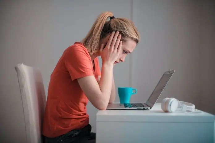 pexels-andrea-piacquadio-3755755 (2) lady with head in her hands staring blankly at laptop