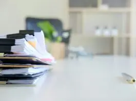 stack of papers and files on a desk