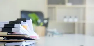 stack of papers and files on a desk