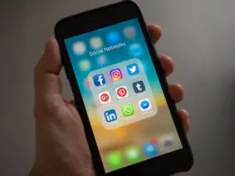 mobile phone showing social media icons on screen
