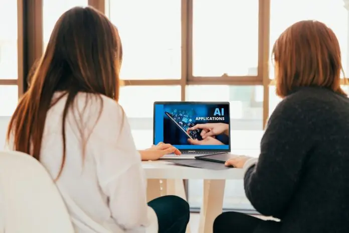 HRHQ Navigating AI in the workplace Work colleagues exploringAI software
