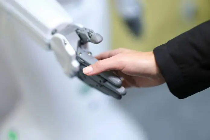 AI Future of Work Robotic and human hand