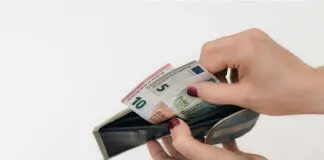 Woman looking through wallet