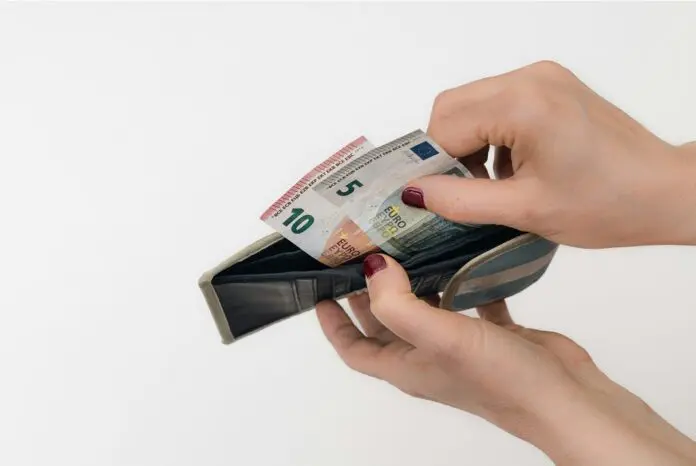 Woman looking through wallet