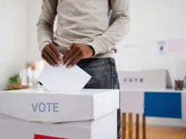 Voter casting vote in polling station