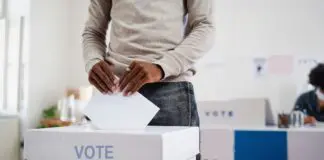 Voter casting vote in polling station