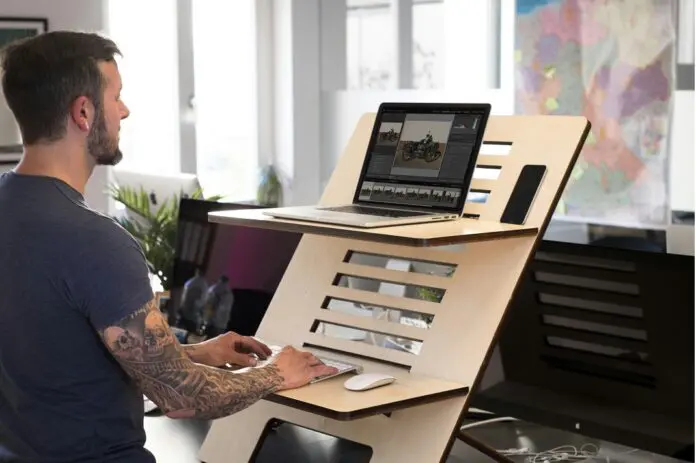 Workplace ergonomics HRHQ Worker standing at workstation