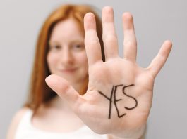 woman holding up hand saying yes