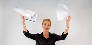 stressed woman throwing papers in the air