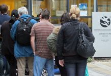 people lining up outside social welfare office