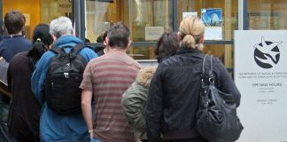 people lining up outside social welfare office